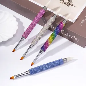 Detail view of professional double-ended nail art brushes with sparkling rhinestone handles.