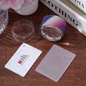 Close-up of rhinestone nail art stamper with floral scraper and transparent plate