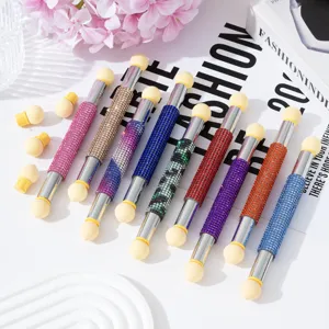 Detailed view of dual-headed nail art pens with colorful rhinestone barrels and sponge heads