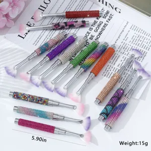 Detailed view of various rhinestone-encrusted nail art fan brushes with sparkling handles
