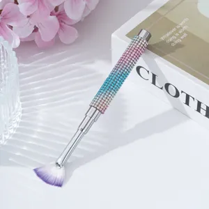 Close-up of rhinestone nail art fan brush with gradient sparkle handle design.
