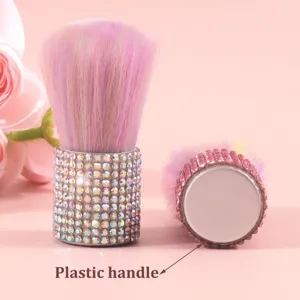 Detail view of pink rhinestone makeup brush handle with plastic material indicator.