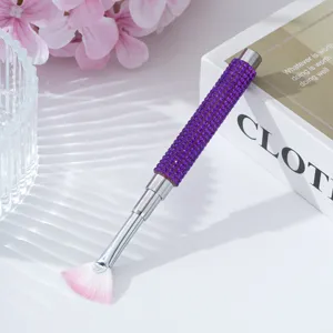 Macro view of the sparkling purple rhinestone handle on this professional nail fan brush.