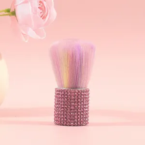 Detailed view of a pink rhinestone makeup brush with soft rainbow-colored bristles