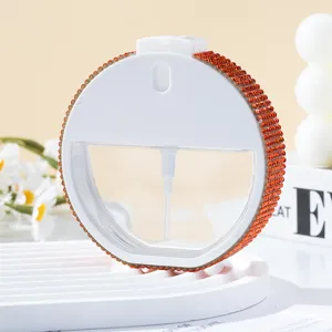 Frasco de perfume redondo portátil de 35 ml con detalles de diamantes de imitación naranja