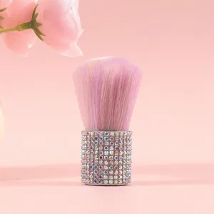 Detailed view of pink rhinestone-studded makeup brush with soft ombre bristles