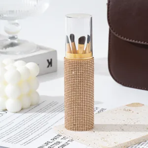 Detailed view of 5-piece makeup brush set in gold rhinestone cylinder case with cap