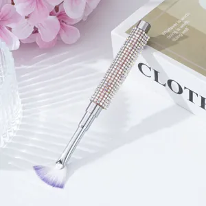 Close-up detail of a rhinestone-studded handle on a professional nail art fan brush.