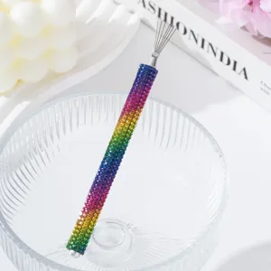 Close-up view of a rainbow rhinestone nail art pull-wire tool with fine metal tips