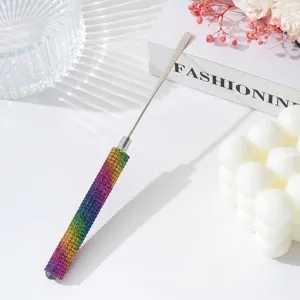 Close-up of rainbow rhinestone handle on stainless steel nail art mixing spatula tool