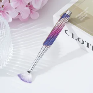 Close-up of luxury rhinestone-studded nail fan brush with gradient purple handle