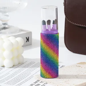 Macro detail of a travel 5-piece makeup brush set in a sparkling rainbow rhinestone case.