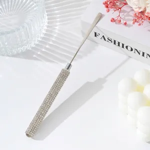 Close-up of rhinestone-encrusted handle on stainless steel nail art mixing tool stick