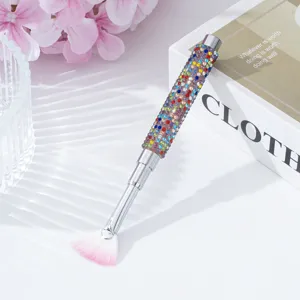 Detail view of nail art fan brush featuring a colorful rhinestone-encrusted handle