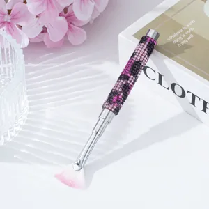 Detailed view of nail art fan brush featuring sparkling purple and black rhinestones