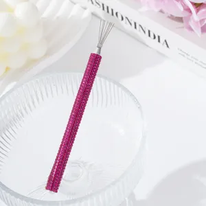 Macro detail of magenta rhinestone handle and metal wires of nail art drawing tool