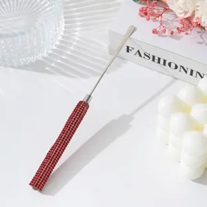 Detailed view of stainless steel nail art spatula with luxury red rhinestone handle