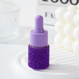 Elegant purple rhinestone-encrusted empty dropper bottle for luxury perfume refills