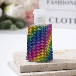 Macro detail of rainbow rhinestone covered travel perfume spray bottle
