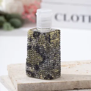 Detail of luxury rhinestone-encrusted travel spray bottle with cheetah pattern