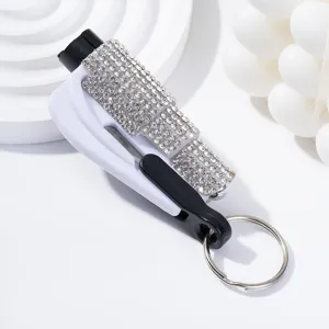 Close-up of a white rhinestone car safety hammer featuring window breaker and seatbelt cutter.