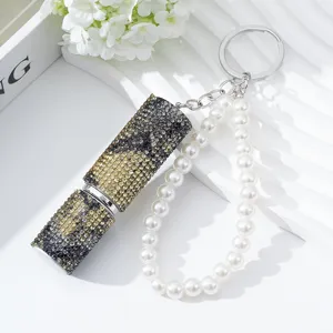 Detailed view of luxury rhinestone perfume atomizer keychain with elegant pearl strap