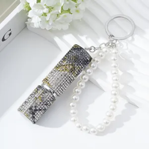 Detail view of a 5ml sparkling rhinestone perfume atomizer with pearl keychain strap