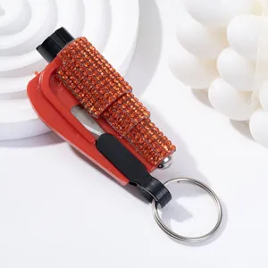 Close-up of a stylish rhinestone-encrusted 2-in-1 car safety hammer and seatbelt cutter tool.