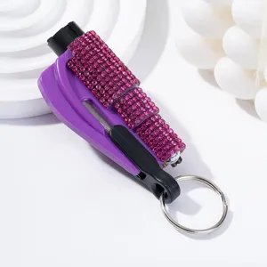 Macro view of a rhinestone-studded purple car window breaker and safety hammer