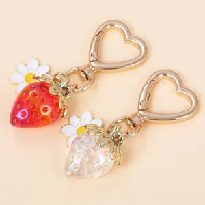 Close-up of sweet strawberry keychains with flower charms and heart-shaped clasps
