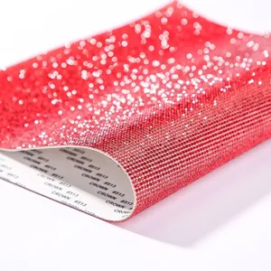 Close-up of self-adhesive red rhinestone sticker sheet with crystal mesh detail
