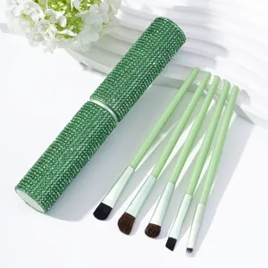 Green rhinestone 5-piece makeup brush set with a matching sparkly cylinder case