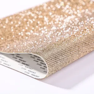 Macro detail of self-adhesive gold rhinestone mesh sheet showing sparkly crystal texture