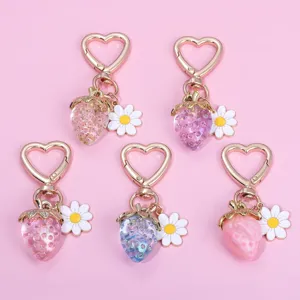 Cute translucent strawberry keychains featuring heart-shaped clasps and daisy charms