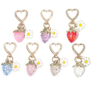 Set of colorful translucent strawberry keychains with daisy charms and heart clips