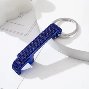Detailed macro view of the sparkling blue rhinestone aluminum bottle opener keychain.