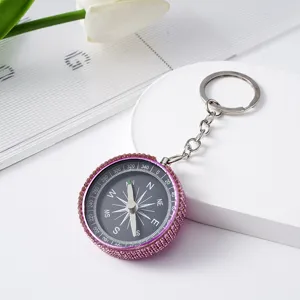 Pink rhinestone studded compass keychain for outdoor navigation and fashion accessory