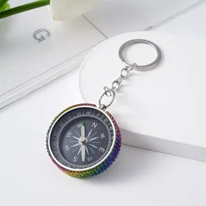 Close-up detail of the rainbow rhinestone rim on a mini aluminum alloy compass keychain