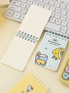 Detailed view of portable A7 spiral notebook featuring blank pages and cute cartoon cover