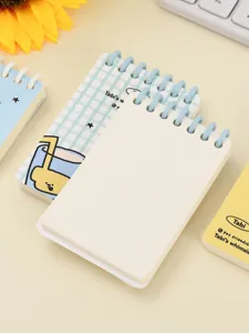 Detailed close-up of A7 mini spiral notebook featuring blank pages and cute blue ring binding.