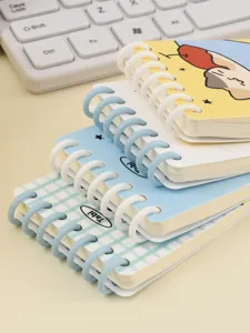 Close-up stack of A7 colorful spiral notebooks with cute cover designs for school