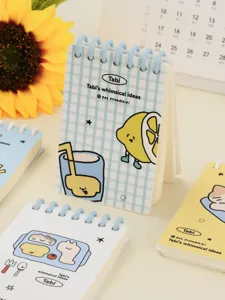 Detailed macro view of cute A7 spiral notebooks with whimsical lemon character illustrations