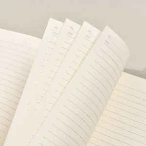 Carnet ligné B5 minimaliste avec en-tête de date et numéro, papier beige de qualité supérieure.