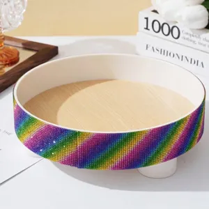 Macro view of a luxury round tray with a sparkling rainbow rhinestone exterior