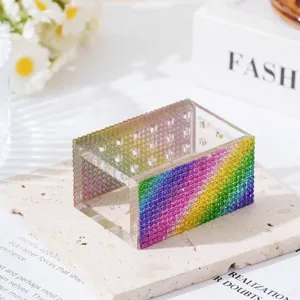 Close-up of rainbow rhinestone edge on 18-hole clear acrylic nail drill bit storage box