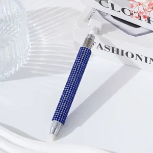 Detailed view of dual-ended nail art dotting pen featuring a blue rhinestone barrel