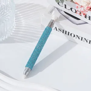 Macro detail view of a sparkling blue rhinestone-studded dual-ended nail art dotting pen