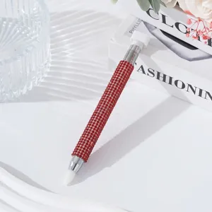 Close-up of dual-ended nail art dotting pen with red rhinestone barrel