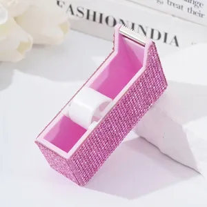 Pink rhinestone encrusted eyelash tape dispenser and cutter for salon use