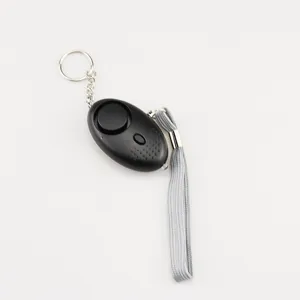 Macro view of black personal safety alarm featuring an LED light and a grey fabric wrist strap